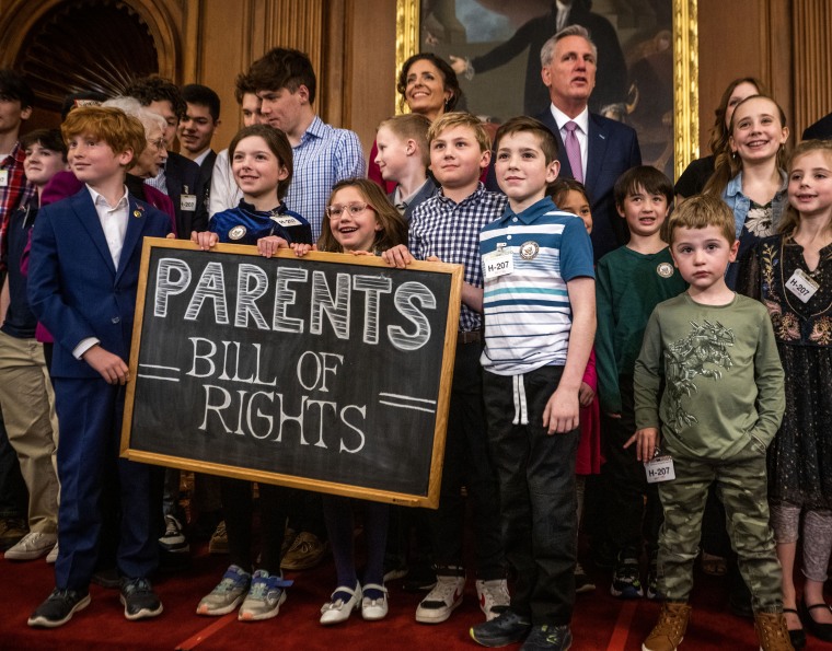 Children hold a sign for the "Parents Bill of Rights" at the Capitol 