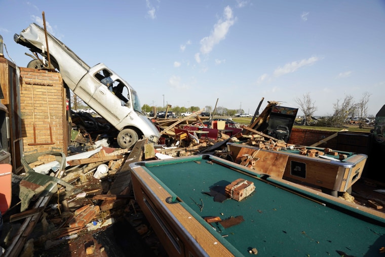 A pickup truck rests on top of a restaurant cooler at Chuck's Dairy Cafe in Rolling Fork, Miss.