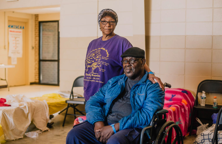 Mae Smith and Will Smith rest as they wait for family to arrive at the Red Cross shelter in Rolling Fork, Miss., on March 26, 2023.