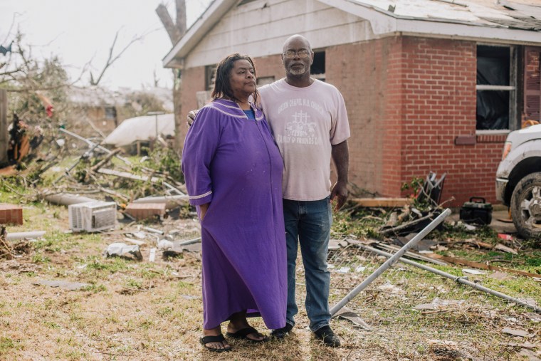 James Anderson and his sister Barbie stand in front of their home where they stayed during the tornado that ripped through Rolling Fork, Miss., two days earlier, on March 26, 2023.