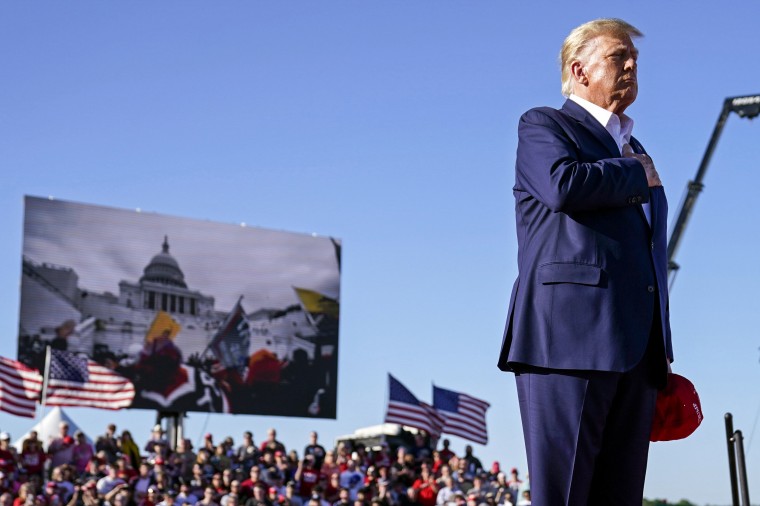 Footage from the Jan. 6 insurrection at the Capitol plays during a campaign rally for former President Donald Trump in Waco, Texas, on March 25, 2023.