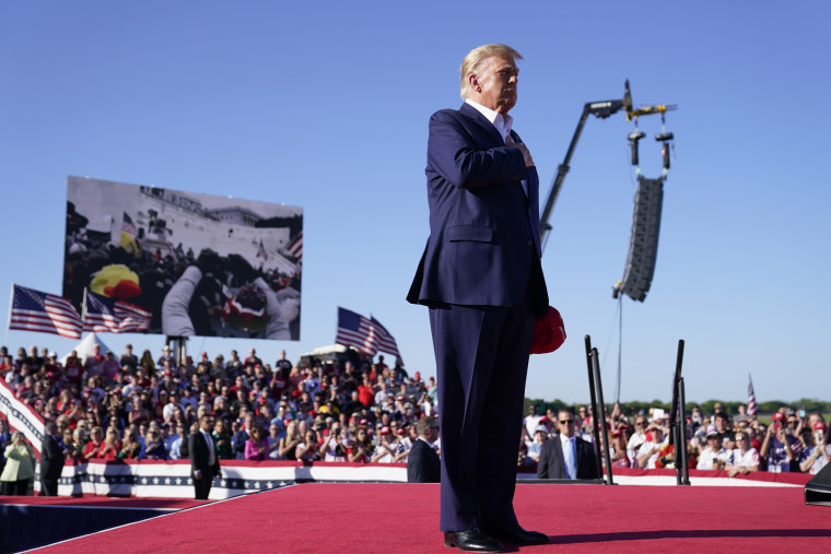 Donald Trump stands while  "Justice for All," is played during a campaign rally, in Waco, Texas