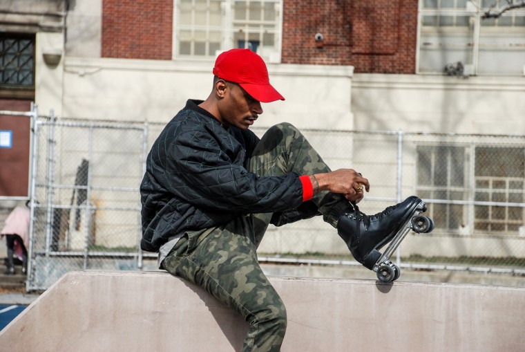 Harry Martin, founder of The Roller Wave, laces up his skates in a Harlem Park.