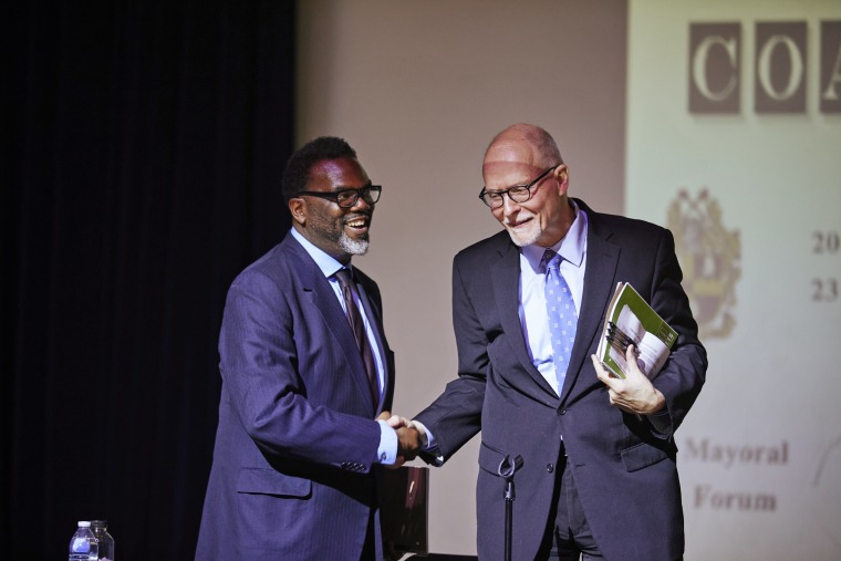 Brandon Johnson, left, and Paul Vallas shake hands after their debate in Chicago on March 18, 2023.