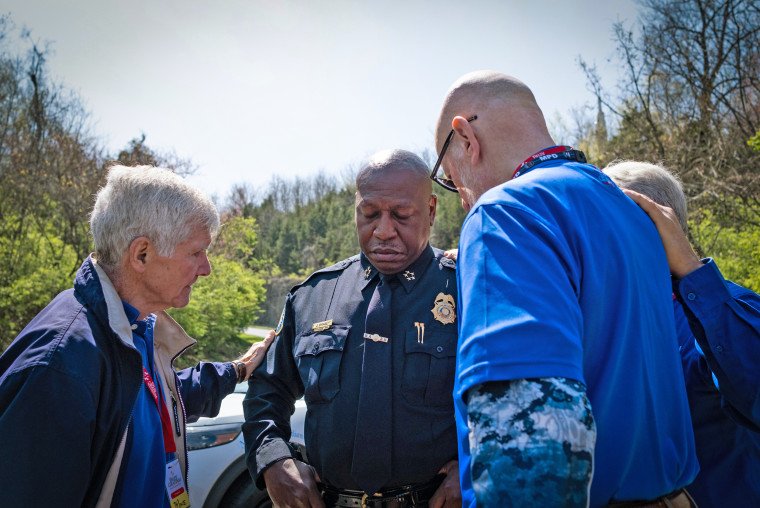 Chief of Police John Drake is prayed for at the entrance of The Covenant School on March 28, 2023 in Nashville, Tenn.
