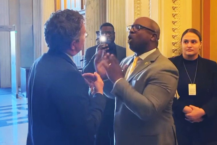 Rep. Jamaal Bowman, D-N.Y., speaks about gun violence to Rep. Thomas Massie, R-Ky., from left, at the U.S. Capitol, on Wednesday.