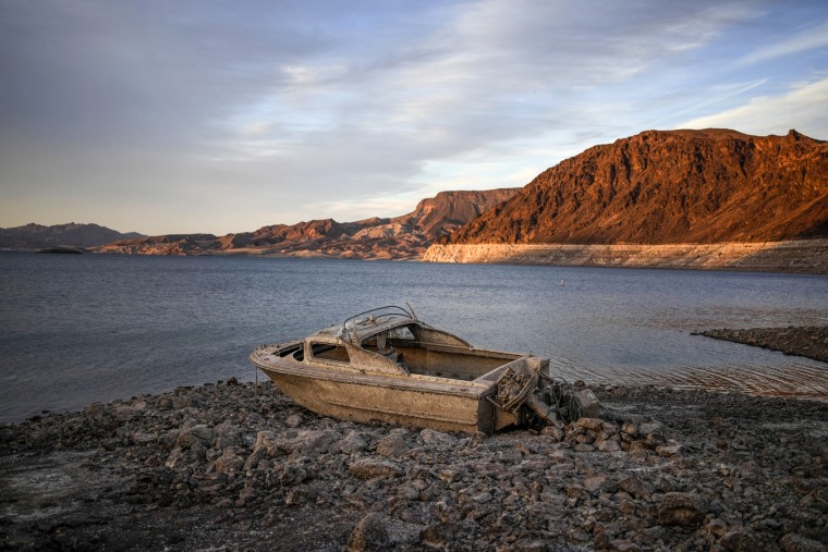 Image: A formerly sunken boat sits high and dry along the shoreline of Lake Mead at the Lake Mead National Recreation Area, on May 10, 2022, near Boulder City, Nev.