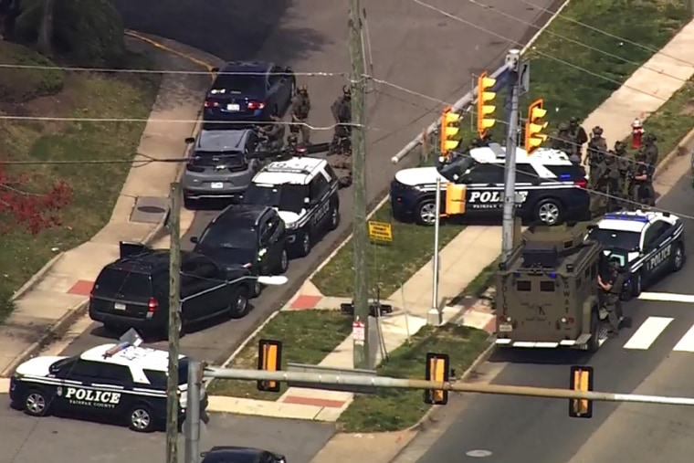 Police surround a vehicle where a woman remains barricaded in her vehicle for more than 24 hours in Northern Va., on March 29, 2023.