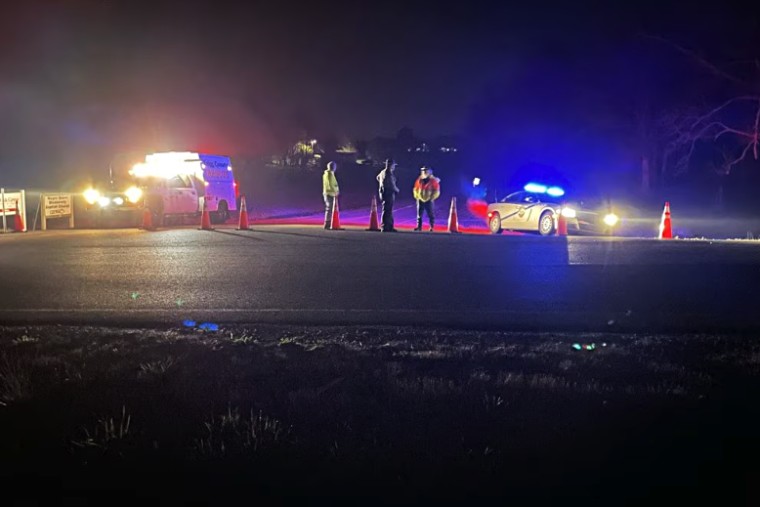 Authorities stand near where two Blackhawk helicopters crashed during a training incident in Trigg County, Kentucky.