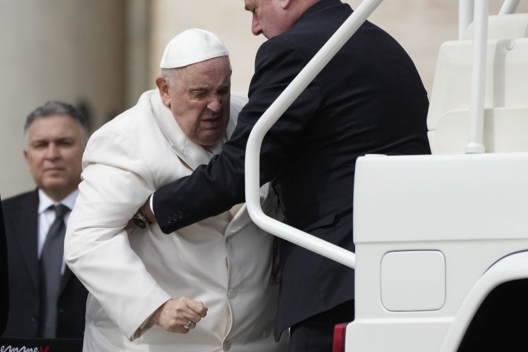 Pope Francis appears in discomfort as he gets into car at the Vatican on Wednesday. 