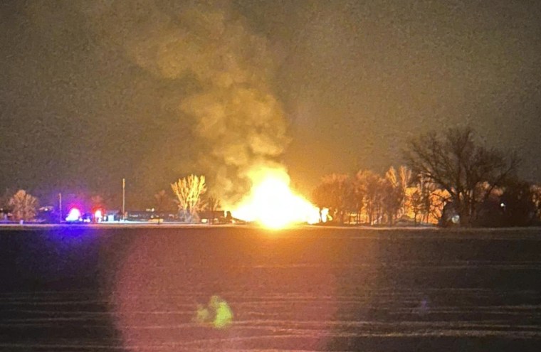 A resident in the area shared a photo of the fiery derailment, saying they were awoken and evacuated by the Raymond Fire Department early Thursday.