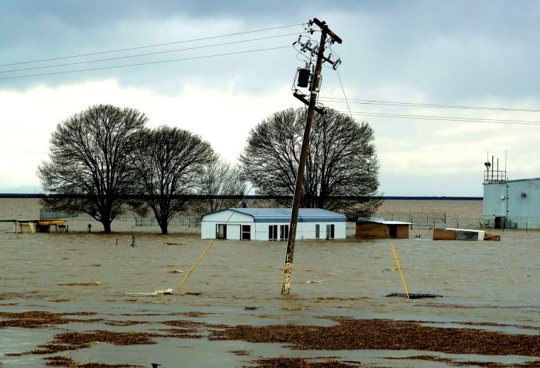 Floodwaters, from a break in levees, surround a farm in Lemoore, Calif.