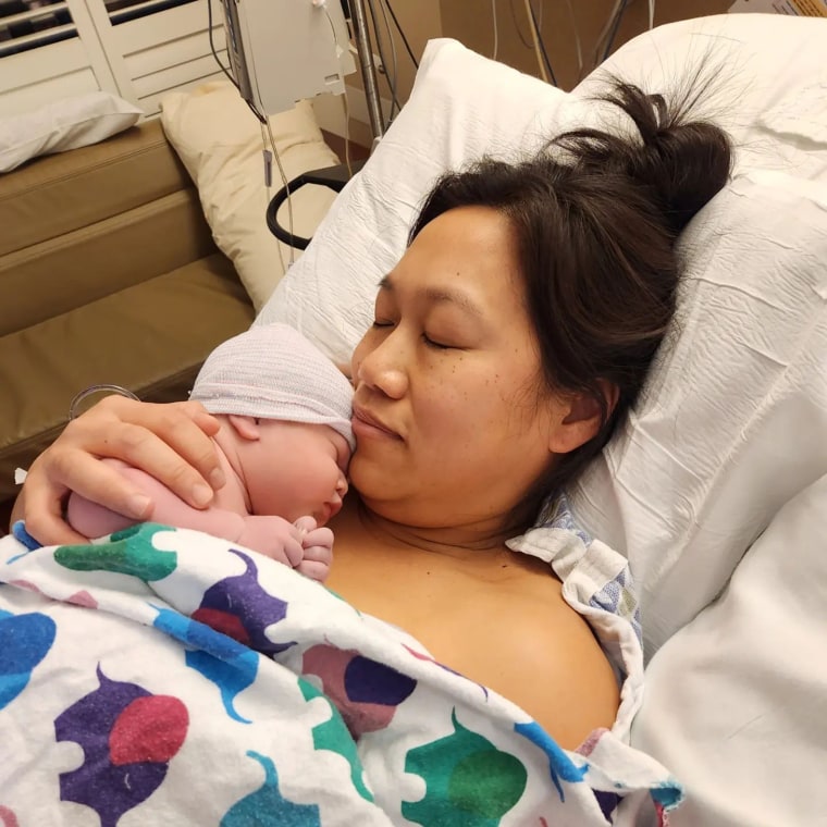 Priscilla Chan snuggles with her newborn daughter.