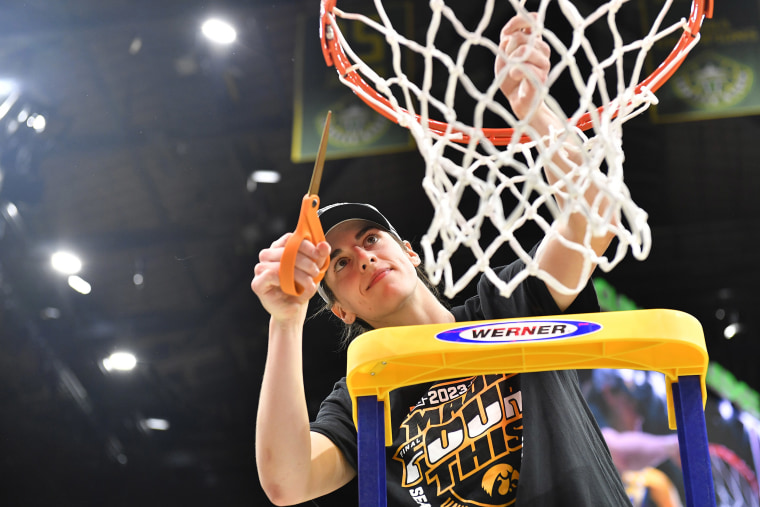 Caitlin Clark cuts the net after Iowa's Elite 8 win over Louisville