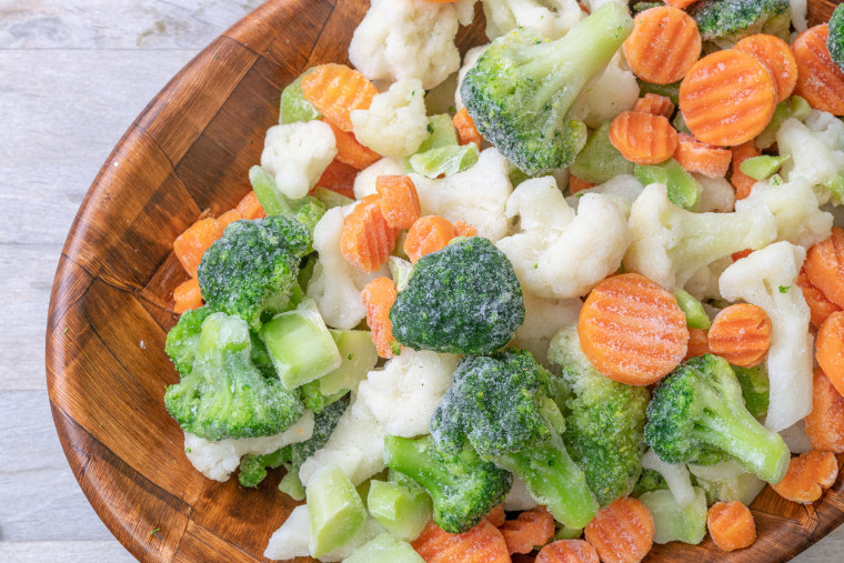 Mixed frozen vegetables on a bowl, top view