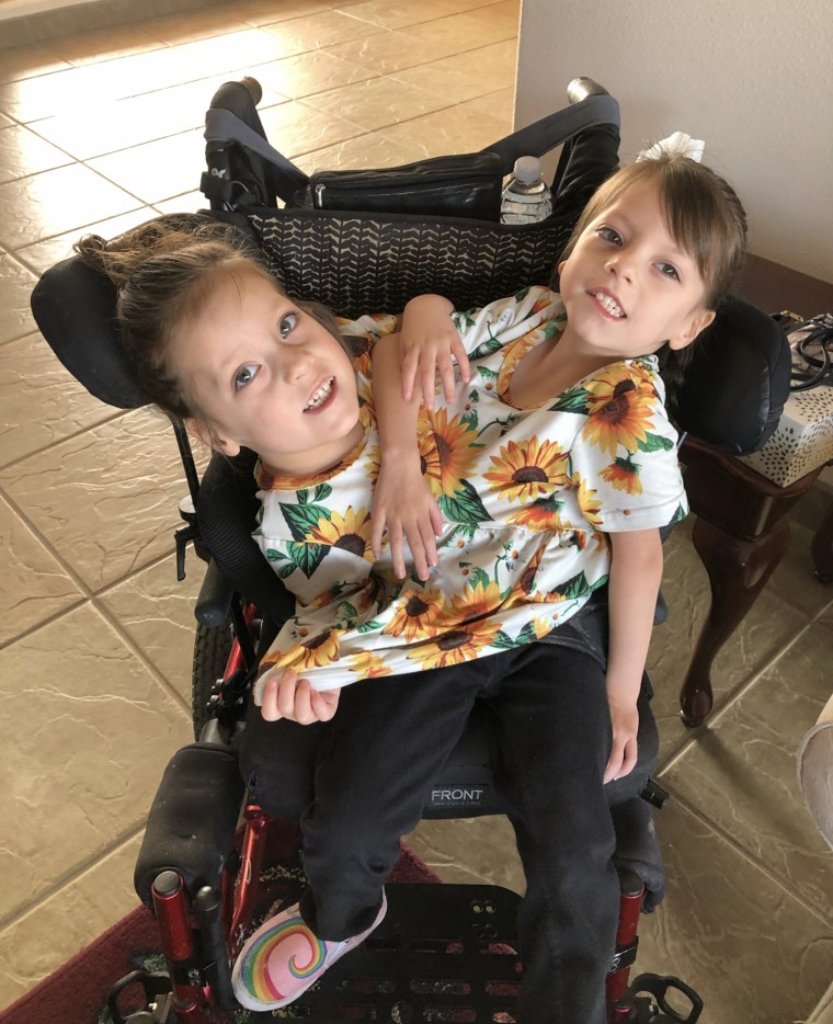 Callie and Carter, who get around in a wheelchair, are learning to walk in physical therapy.  