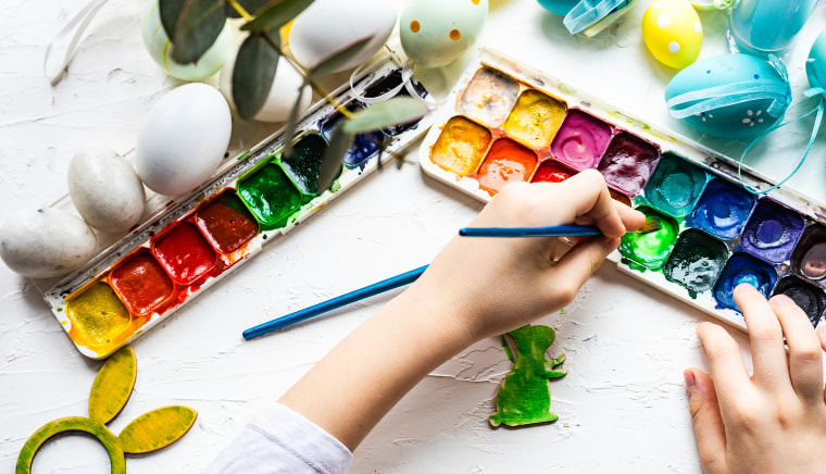 Boy's hands painting an Easter bunny decoration