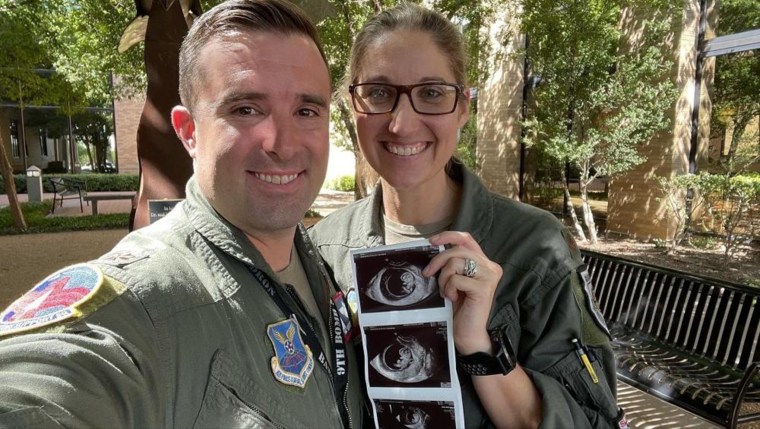 Lauren and Mark Olme pose with their baby's ultrasound.
