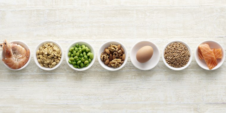 Allergenic foods in bowls - shellfish, nuts, soybeans, eggs, wheat, fish.