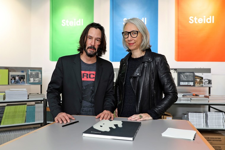 Keanu Reeves and Alexandra Grant with their book "Ode to happiness" during "Paris Photo."