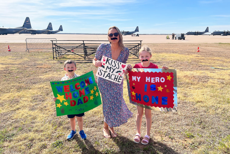 Maxine Clegg with her kids, Maddie and Ethan, wait to welcome home Lt. Col. Nate Clegg.