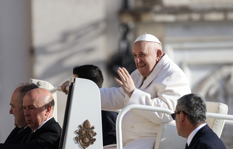 Pope Francis waves as he arrives on his popemobile to lead his weekly audience in St. Peter's Square