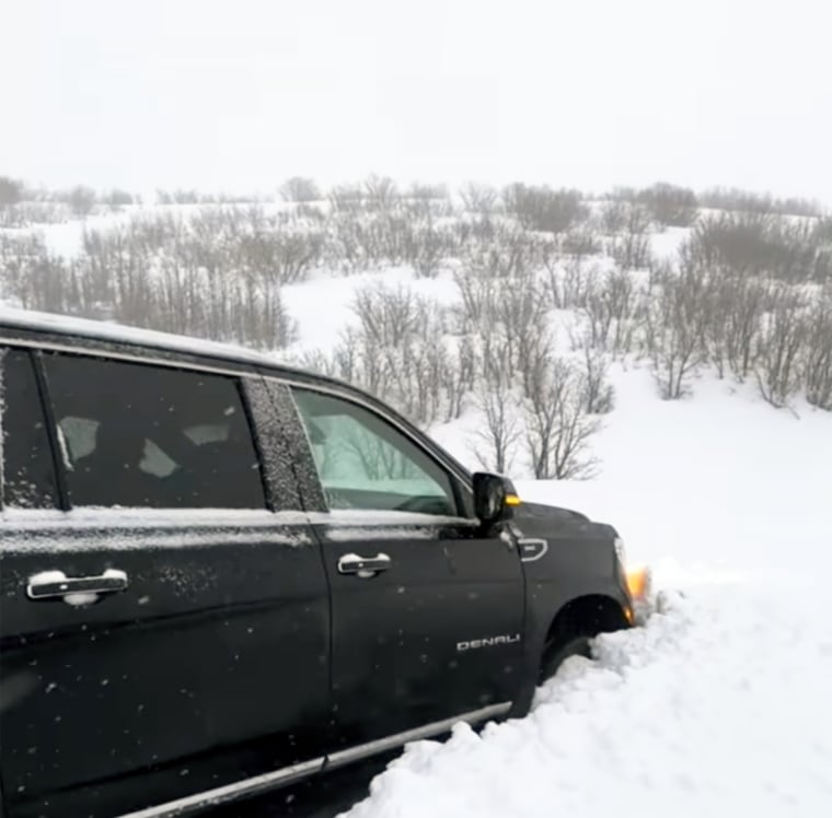 Marks' black SUV stuck in a snowbank.