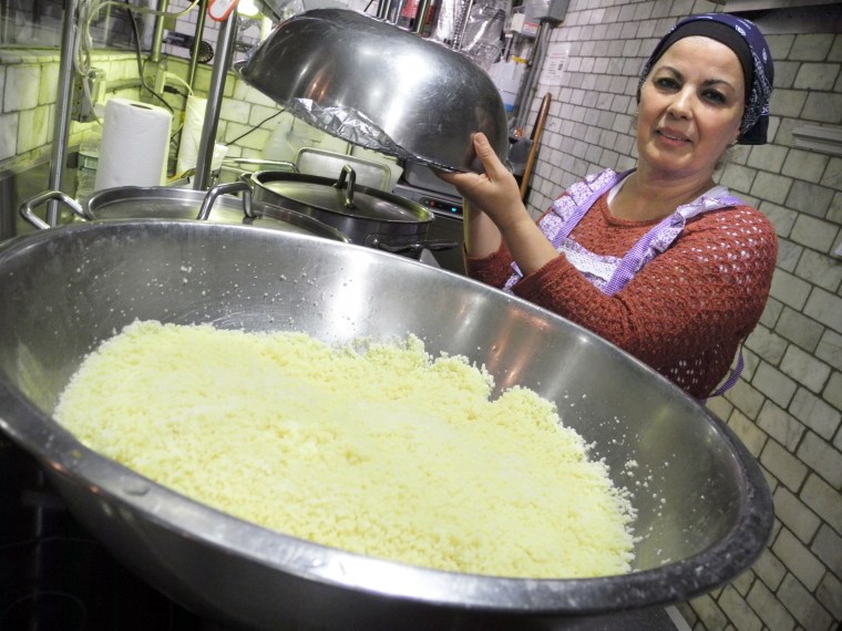 Habiba Hachemi from Algeria seen in one of two kitchens of 'Enoteca Maria', a restaurant where grandmothers (Nonnas) make food, on Staten Island, New York.