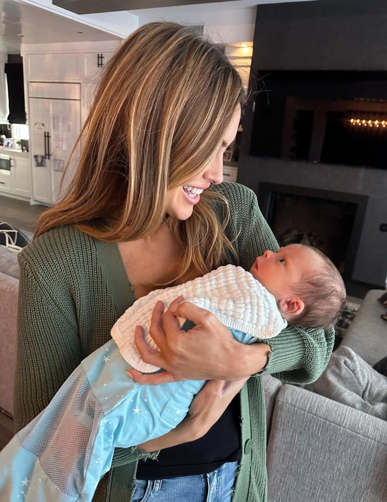 Chrishell Stause holds baby Tristan.