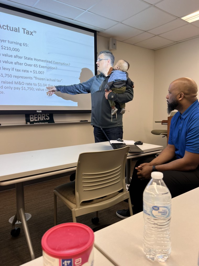 Baylor University lecturer Bobby Ott held the foster baby of doctoral student Traniece Brown-Warrens so she could focus in class.