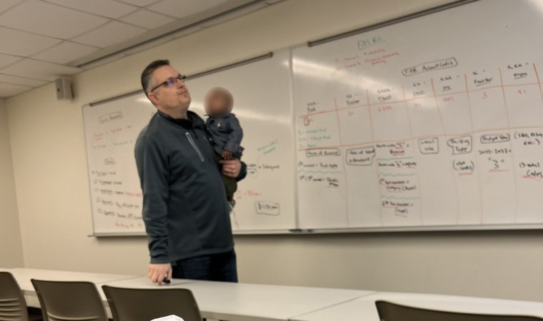 Bobby Ott, a lecturer at Baylor University, volunteered as class babysitter when student Traniece Brown-Warrens had her hands full.