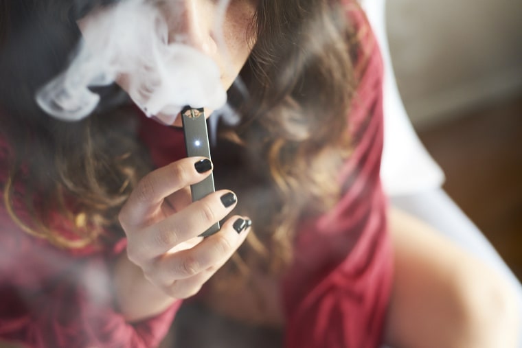 A person smokes a Juul e-cigarette in New York on July 8, 2018.