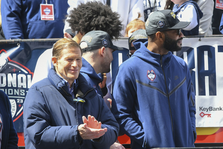  U.S. Senator Richard Blumenthal (left) watches  the rally during the UConn Championship Parade on Saturday in Hartford.