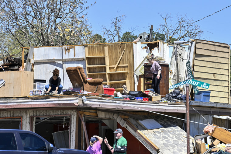 People clean up after the devastating tornadoes in Little Rock, Ark., on April 1, 2023.