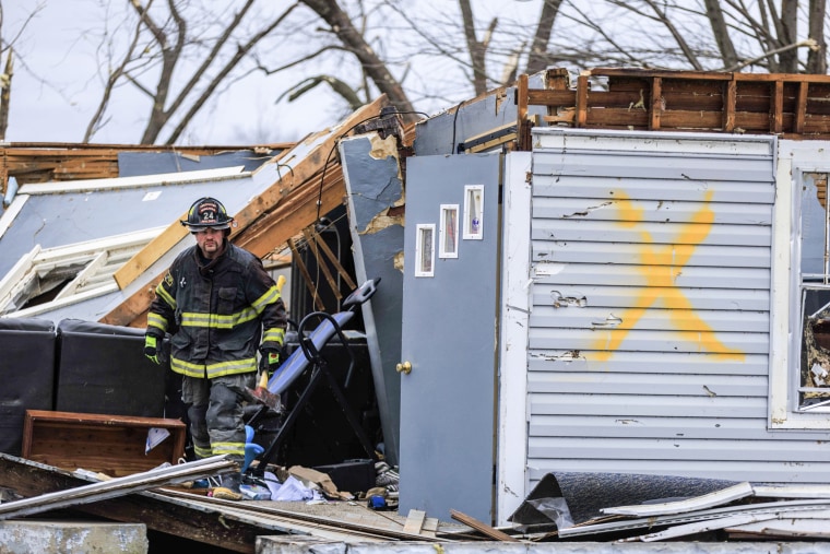 A firefighter helps with search and rescue operations after a tornado in Sullivan, Ind., on April 1, 2023.