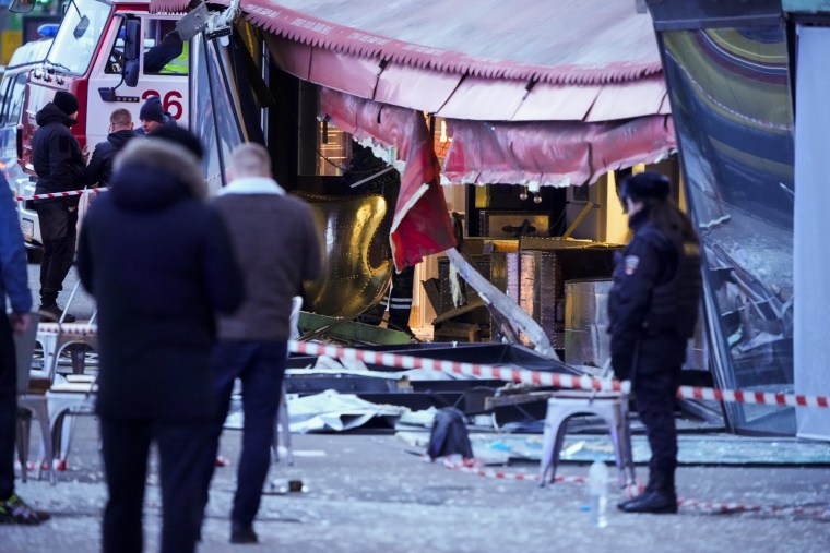 Investigators and police officers respond to an explosion at a café in St. Petersburg, Russia, on April 2, 2023.