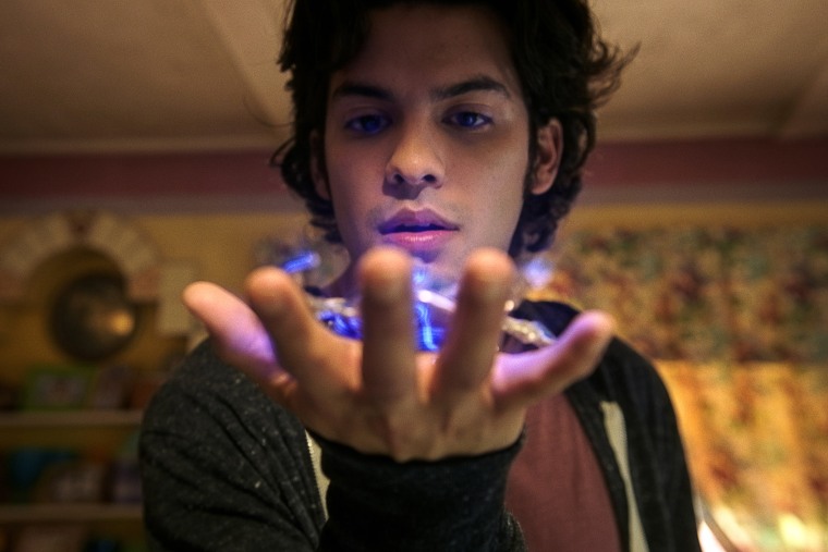Xolo Maridueña as Jaime Reyes, with an ancient alien artifact known as the Scarab.