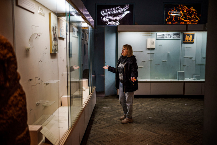 Olga Honcharova, temporary director of the Kherson Regional Museum, shows empty display cases in Kherson, Ukraine, on Dec. 22, 2022.