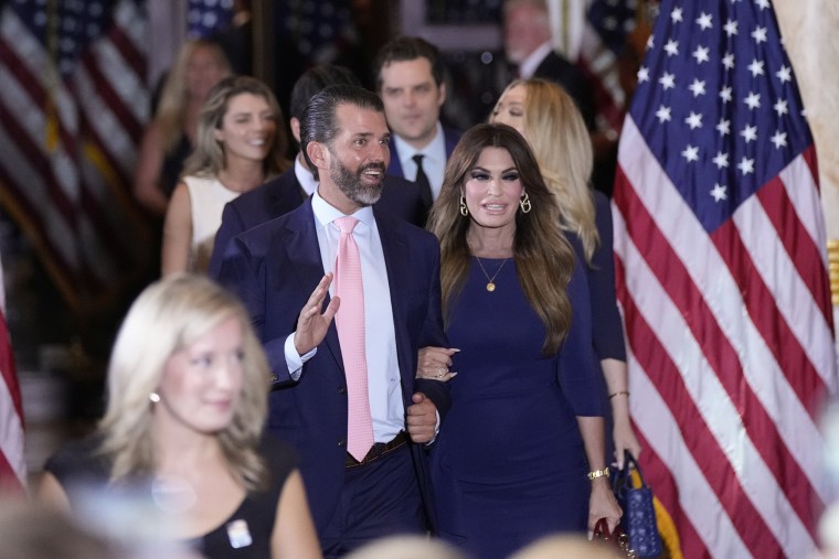 Donald Trump Jr., center left, arrives with his fiance, Kimberly Guilfoyle, before former President Donald Trump speaks at his Mar-a-Lago estate hours after being arraigned in New York City, Tuesday, April 4, 2023, in Palm Beach, Fla. (AP Photo/Rebecca Blackwell)