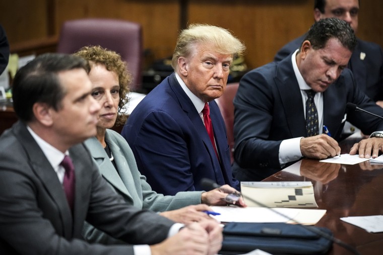 Image: Former President Donald Trump sits at the defense table with his defense team in a Manhattan court on April 4, 2023, in New York.