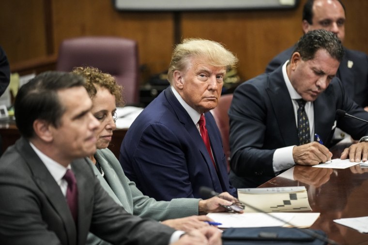 Image: Former President Donald Trump sits at the defense table with his defense team in a Manhattan court during his arraignment on April 4, 2023, in New York.