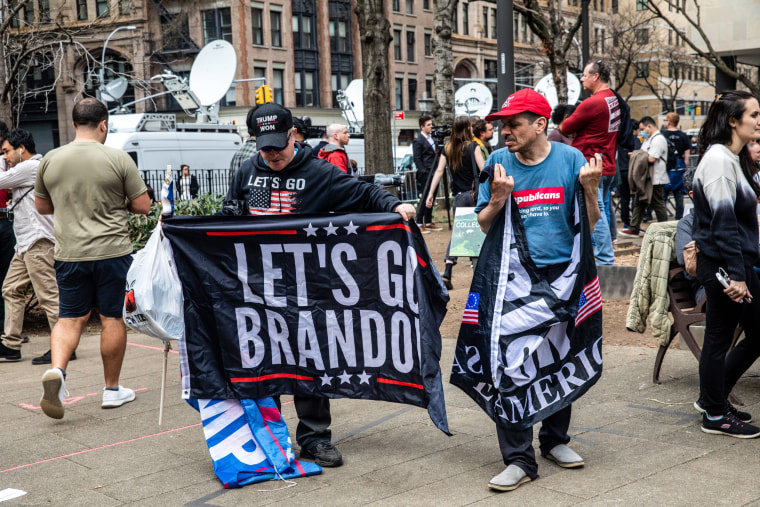 Trump supporters hold flags outside New York Criminal Court following former President Donald Trump’s arraignment on 34 counts on April 4, 2023. 