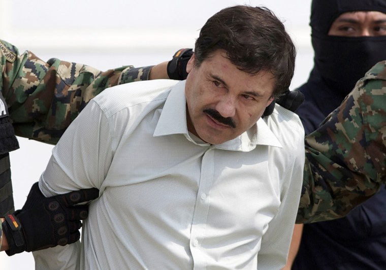 Joaquin "El Chapo" Guzman is escorted to a helicopter in Mexico City