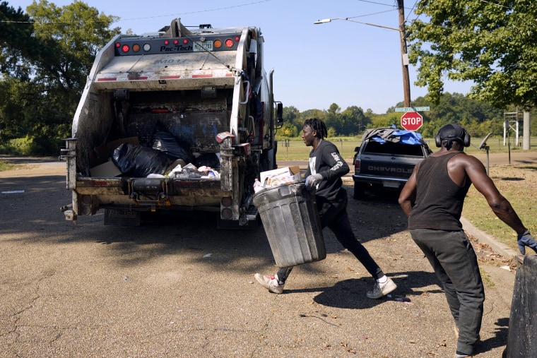Richard's Disposal employees load up a trash truck in Jackson, Miss.