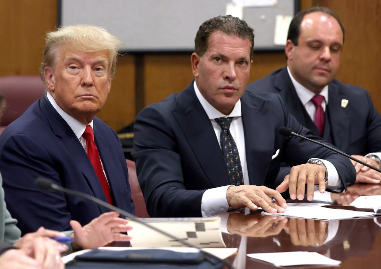 NEW YORK, NY - APRIL 04:  Former U.S. President Donald Trump sits with his attorneys Joe Tacopina and Boris Epshteyn inside the courtroom during his arraignment at the Manhattan Criminal Court April 4, 2023 in New York City. Trump pleaded not guilty to 34 felony counts stemming from hush money payments made to adult film star Stormy Daniels before the 2016 presidential election. With his indictment, Trump will become the first former U.S. president in history to be charged with a criminal offense.