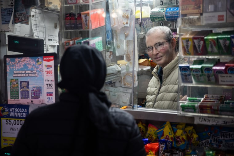 Abul Kalam Azad helps a customer at his newsstand on April 4, 2023, near New York Criminal Court.
