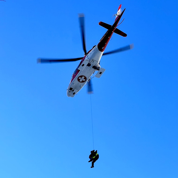 A rescue helicopter transports a male climber with serious injuries over Duchesne County near Indian Canyon.