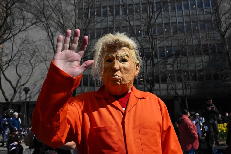 A demonstrator wears a Donald Trump mask during a protest outside the Manhattan District Attorney's office in New York
