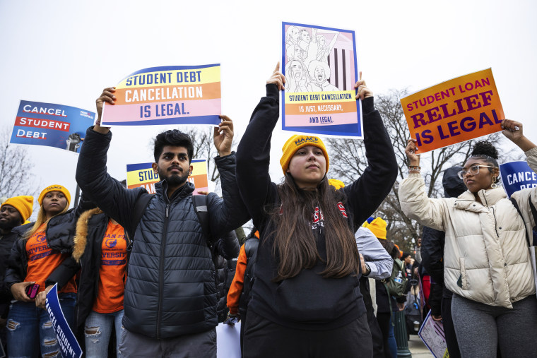 People take part in a student debt cancellation rally outside the Supreme Court in Washington, D.C.