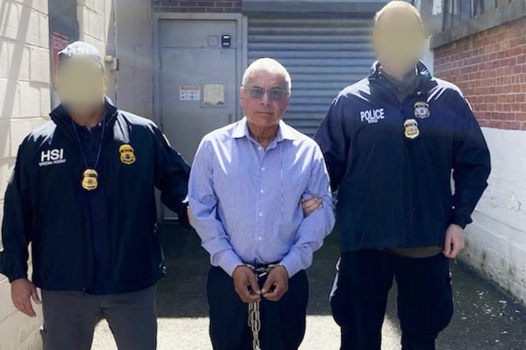 Roberto Antonio Garay Saravia, center, was arrested on Tuesday. (Officers' faces blurred by source.)